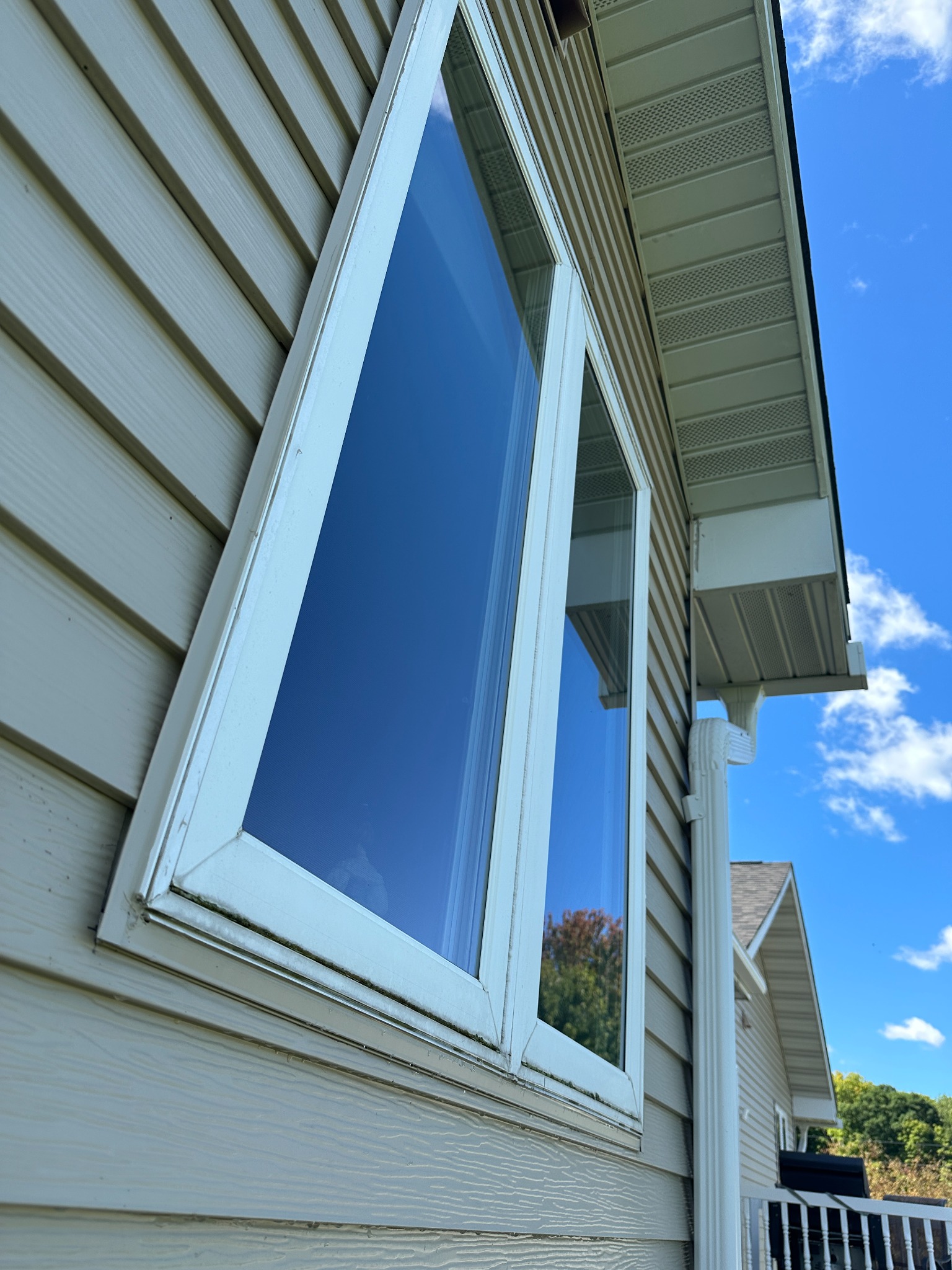Clean exterior residential window and siding after professional window cleaning in Western Wisconsin